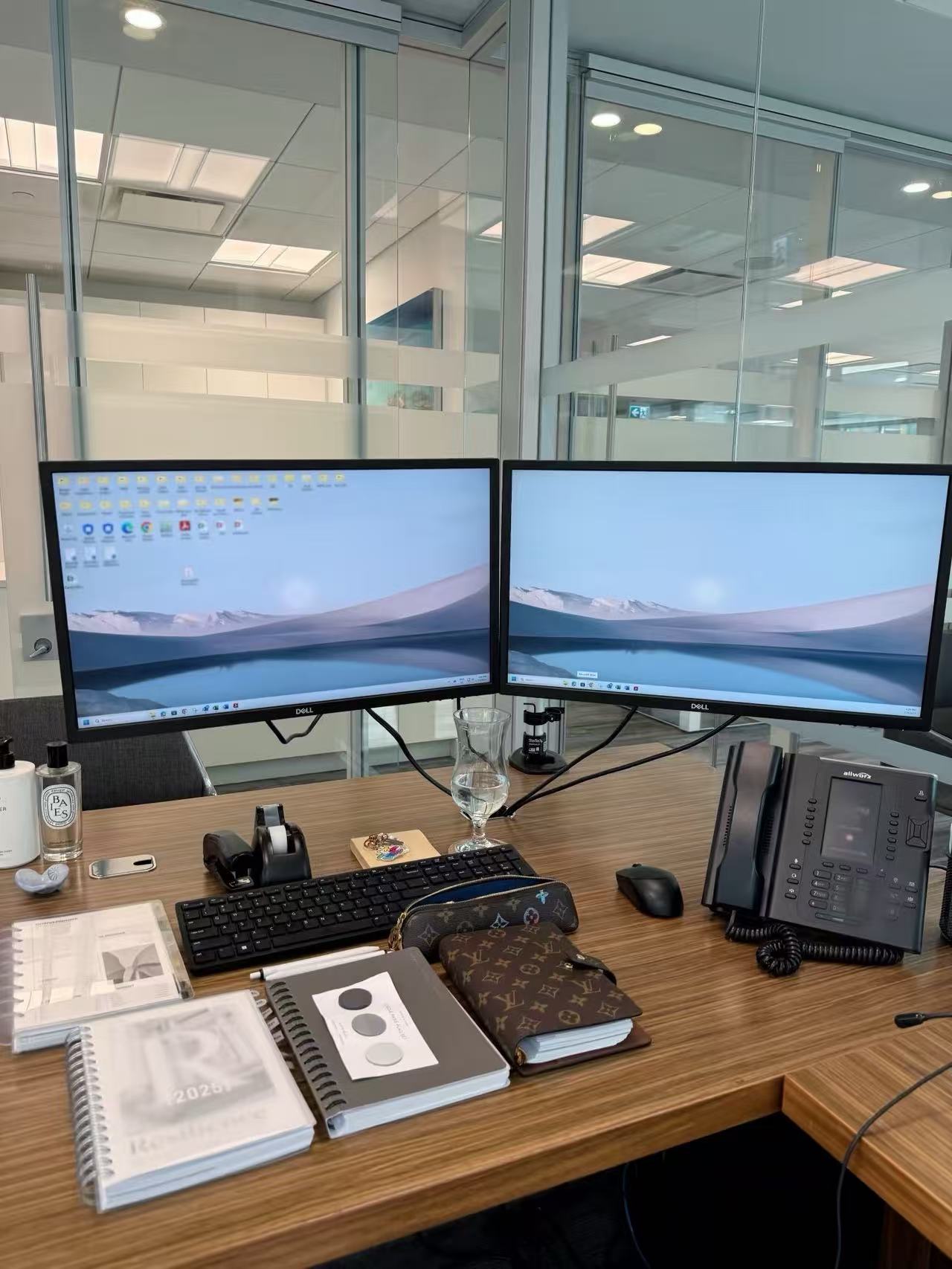Organized professional office workspace with dual monitors
